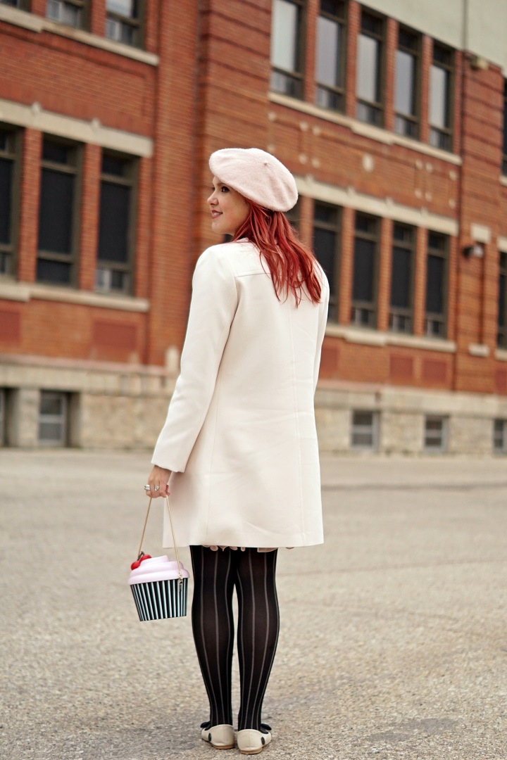 Winnipeg Style Fashion, Loly in the Sky Noela eye lash flats, Kate Spade New York cupcake clutch bag, Anthropologie pink ostrich feather belt, Le chateau beige classic coat, BCBG Jaylin pleated pink skirt